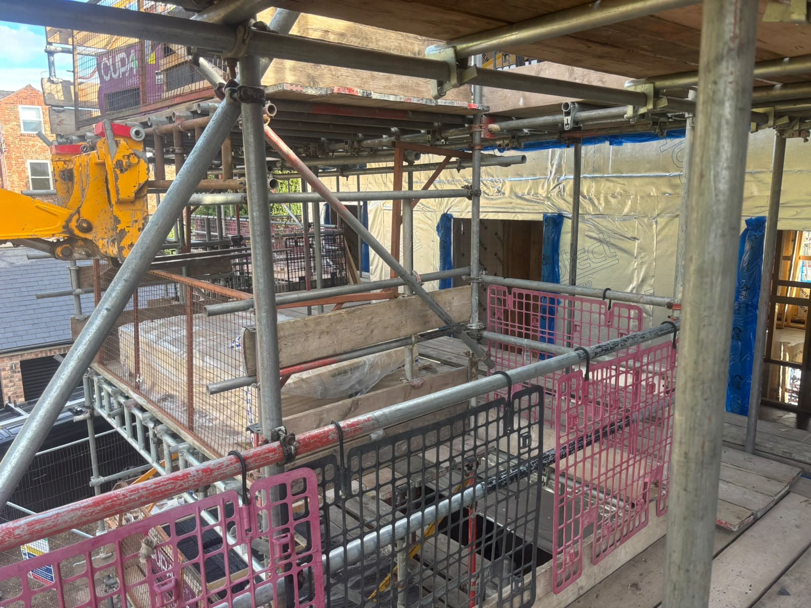 Wrapped wall panels viewed from scaffolding